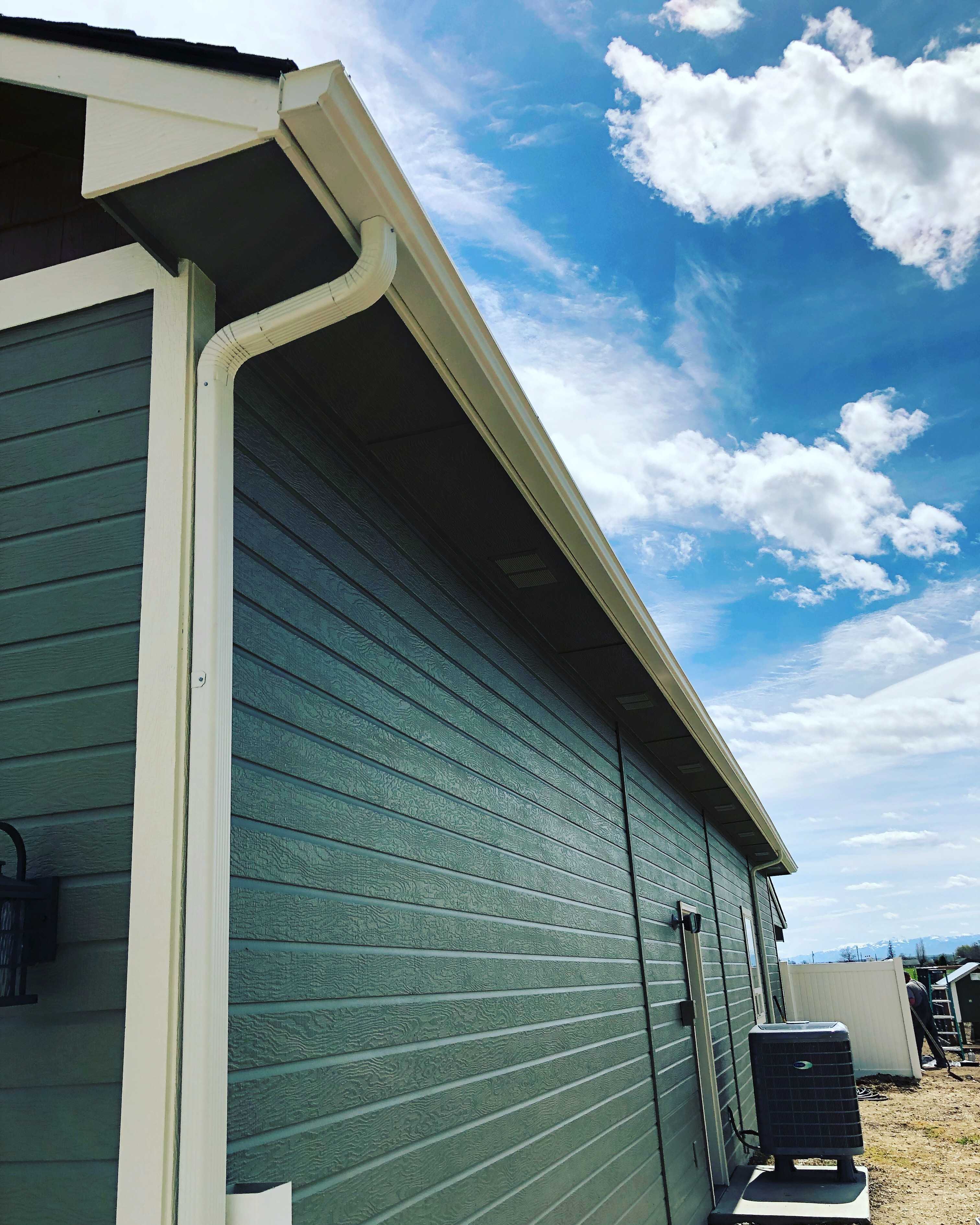 Gutters on a dark green house in Middleton, ID.