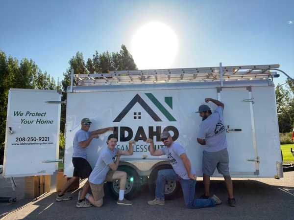 Idaho Seamless Gutter team posing in front of trailer